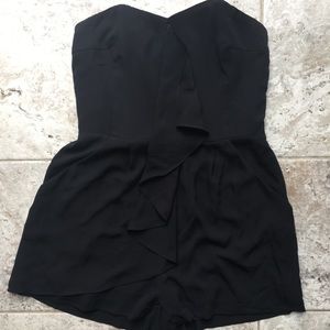 Black strapless romper with ruffle